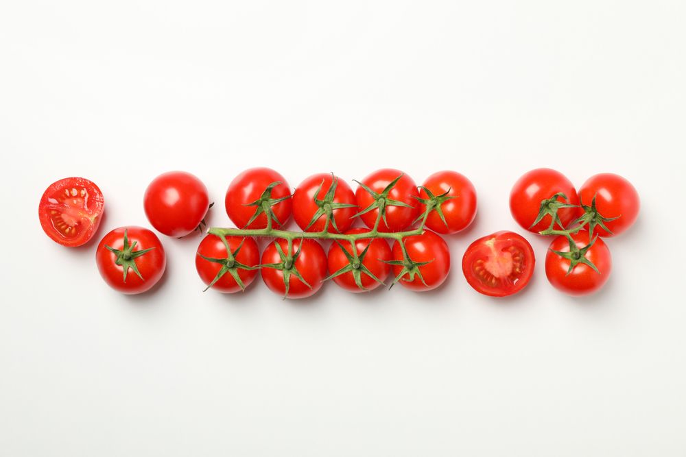 Fresh ripe tomatoes on light background, top view