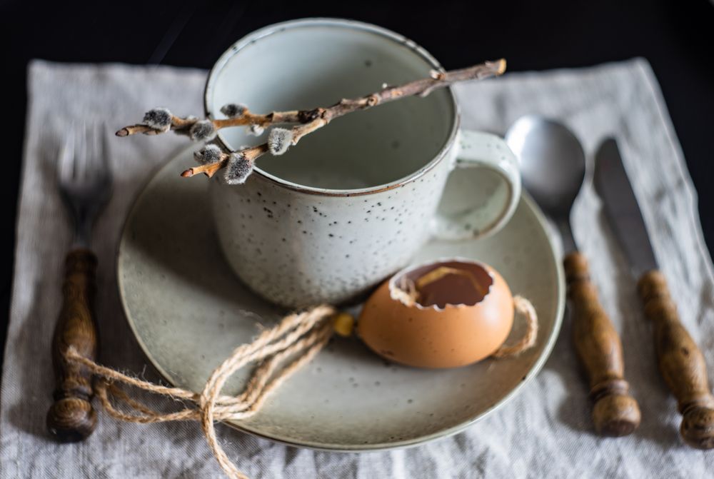 Easter table setting with cup, pussy willow decorative egg shell