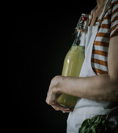 Female with bottle of elderflower syrup