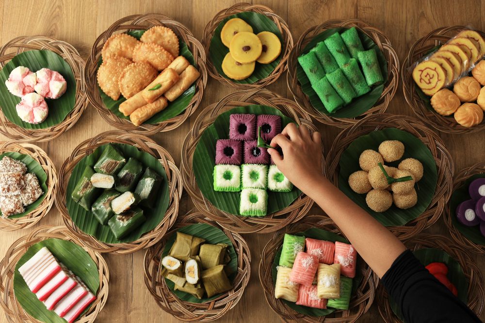 Hand reaching for jasan pasar festive Indonesian treats