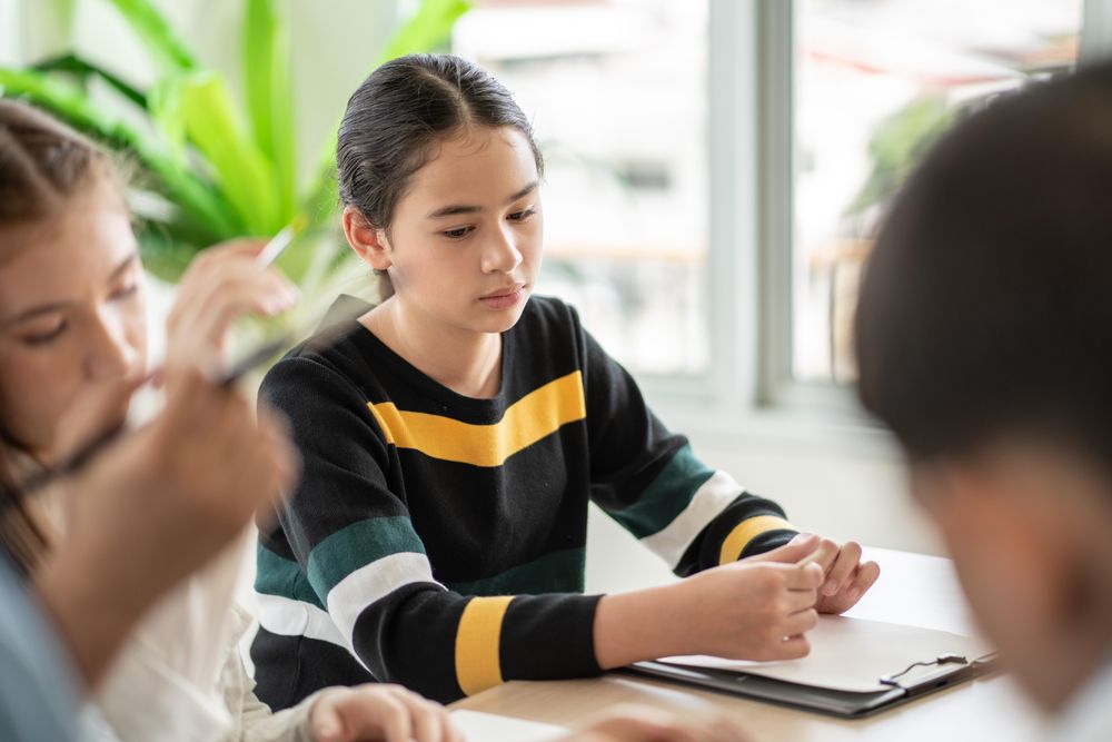 Female student with notepad in class