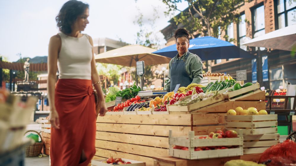 Establishing Shot of Small Business Owners Selling a Organic Fruits and Vegetables at an Outdoors Farmers Market.