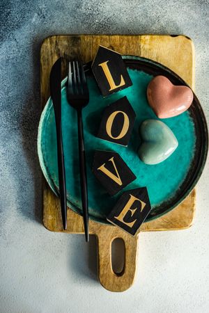 Teal plate with the word "love" and heart decorations