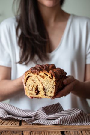 Faceless woman with appetizing cinnamon babka
