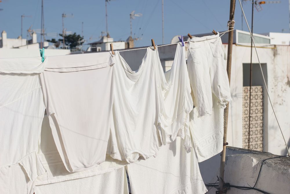 Various clothes hanging and drying in wind on rope