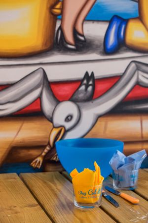 Restaurant table in front of colorful mural