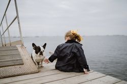 Anonymous girl with dog on pier