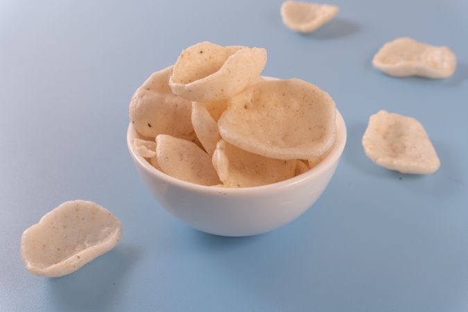 Crispy traditional crackers (kerupuk) served in a ceramic bowl