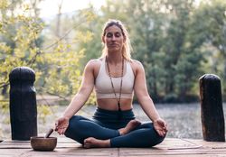 Young woman meditating and doing yoga in nature