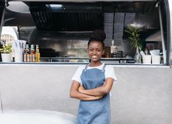 Saleswoman with arms crossed looking away