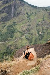 Back of woman resting and taking in view over Sri Lankan hills