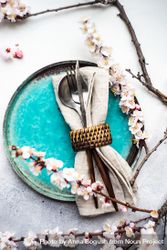 Table setting with delicate apricot blossom around elegant teal plates 4OdrDa