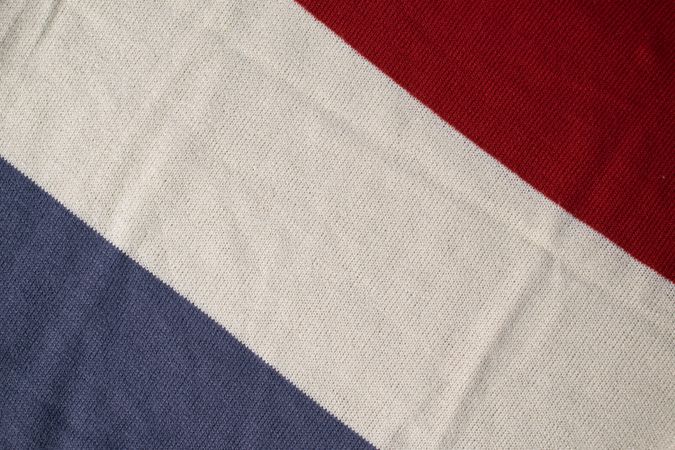 Triple color grey milk and red on knitted fabric background texture.