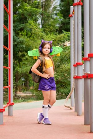 Girl with Skateboard In Playground