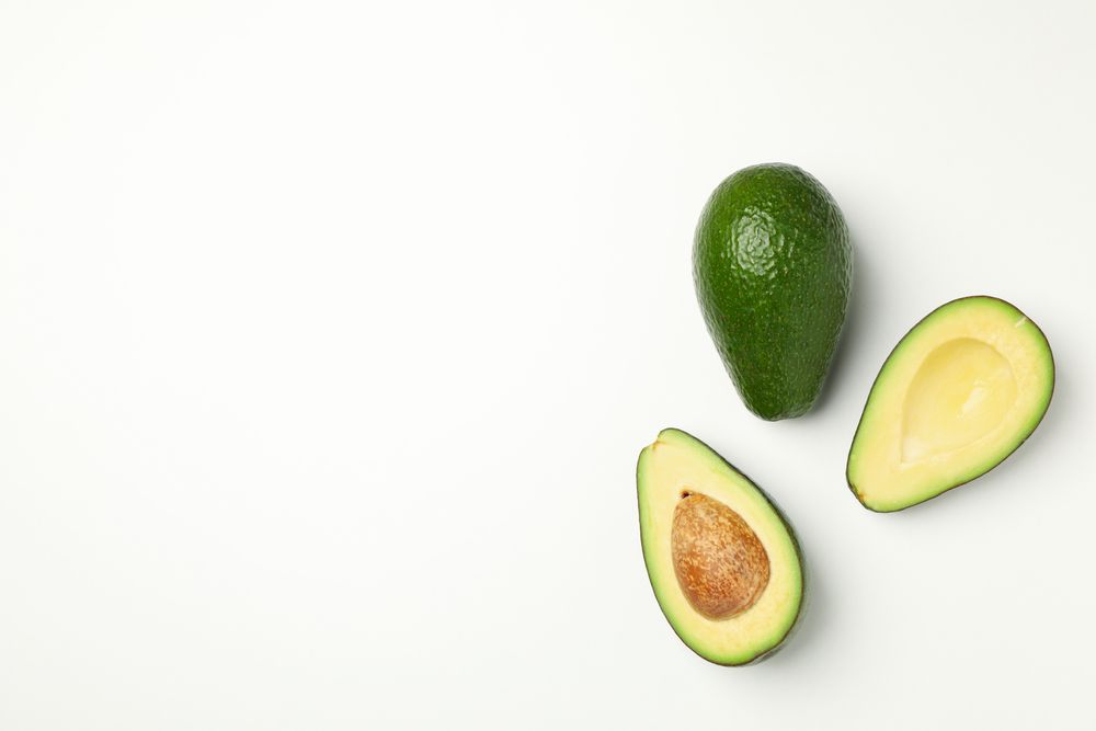 Ripe fresh avocado on plain background, top view