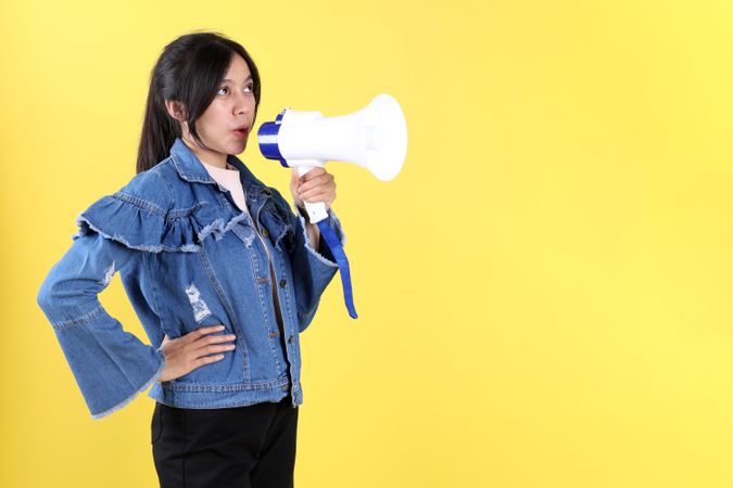 Indonesian Asian Excited Woman Shouting Holding a Megaphone