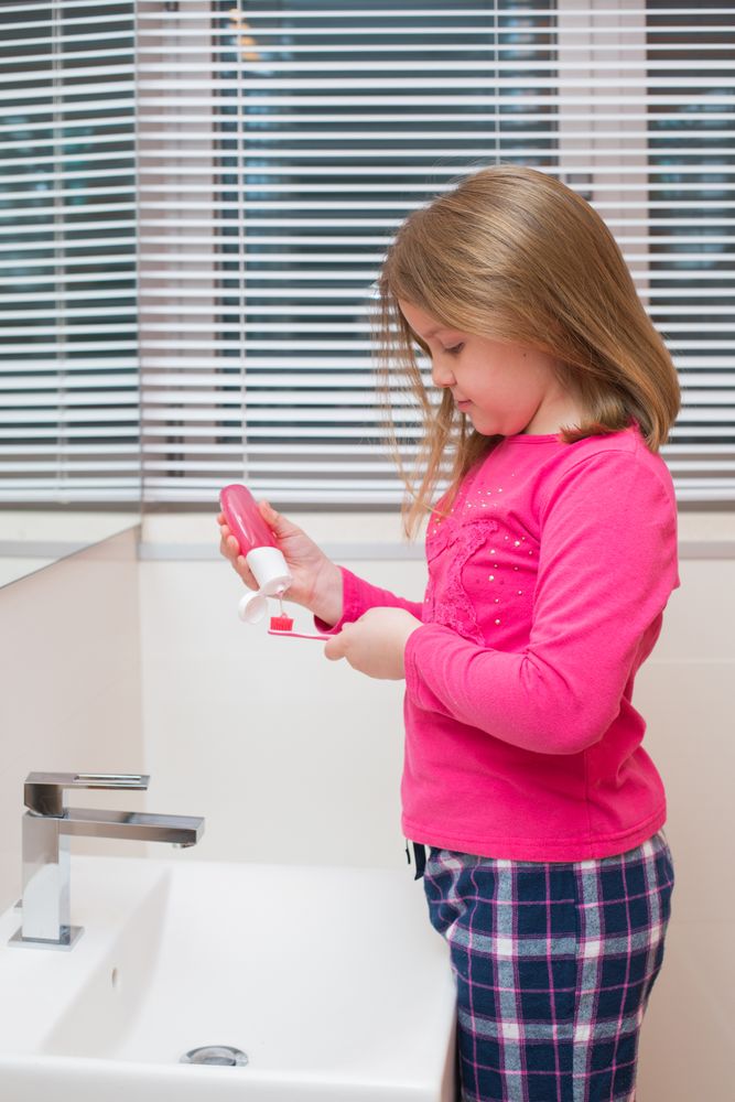 Cute girl brushing her teeth