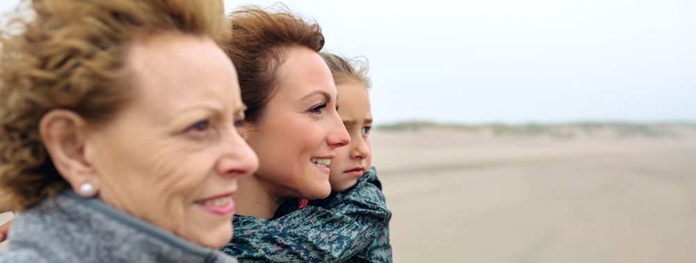 Three generations of females looking at sea