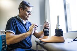 man fixing a prosthesis in a workshop