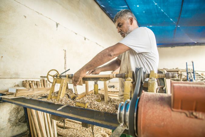 Man using woodworking machine at workplace
