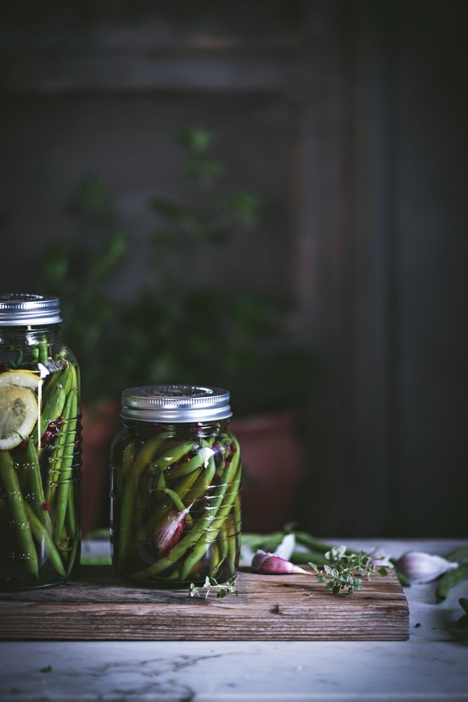 Fresh green vegetables with fruits and glass jars