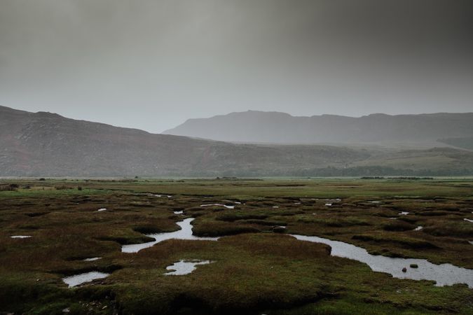 Valley covered with water patches surrounded by hills