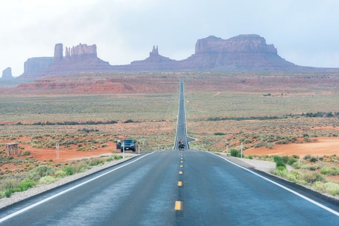 Asphalt road at scenic mountain valley and power line