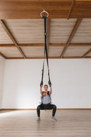 Mother exercising with baby in gym