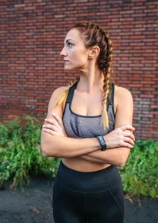 Sporty woman with crossed arms posing