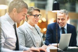 Professional colleagues sharing a laugh during a meeting