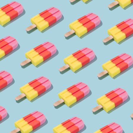 Pattern of colorful ice cream popsicle on pastel blue background