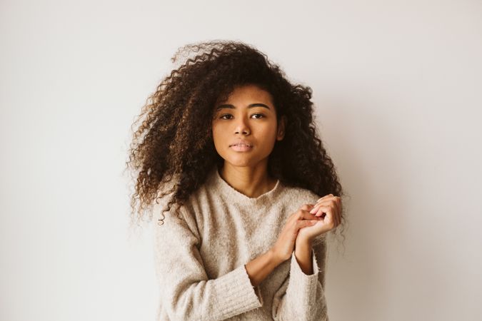 Curly haired Black woman in beige