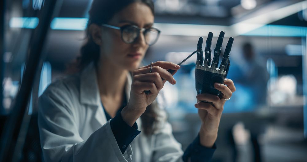 Portrait of Young Female Scientist Working in Technological Research and Development Company, Assembling an Innovative Bionic Prosthetic Hand.