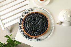 Concept of tasty breakfast with blueberry pie on table