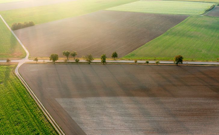 Drone shot with agricultural fields at sunrise, in Baden Wurttemberg, Germany