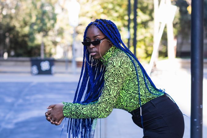 Determined Black woman in stylish wear in city