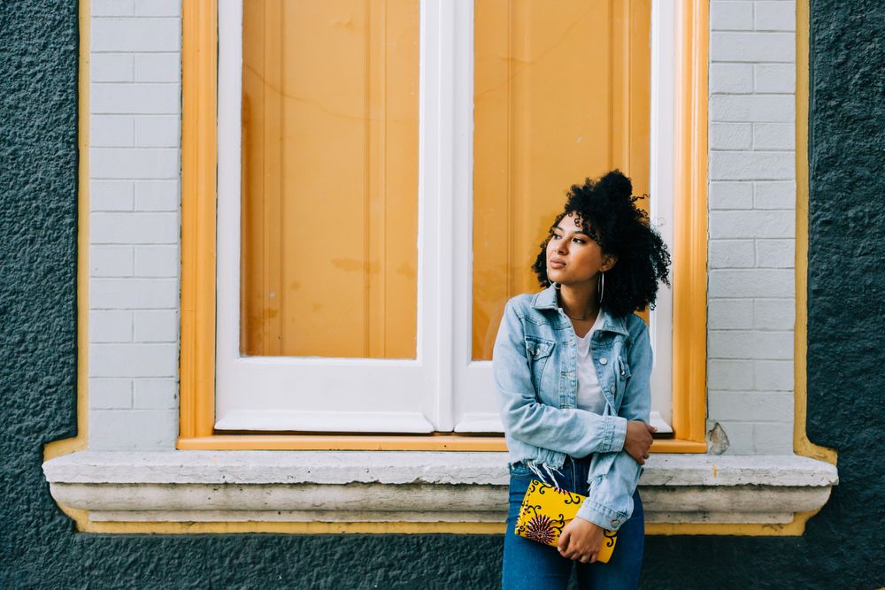 Smiling female by yellow window