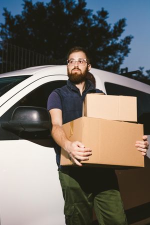Dedicated upset courier with cartons waiting client for delivery completion