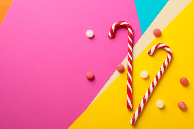 Composition with sweet candies on multicolored background, space for text