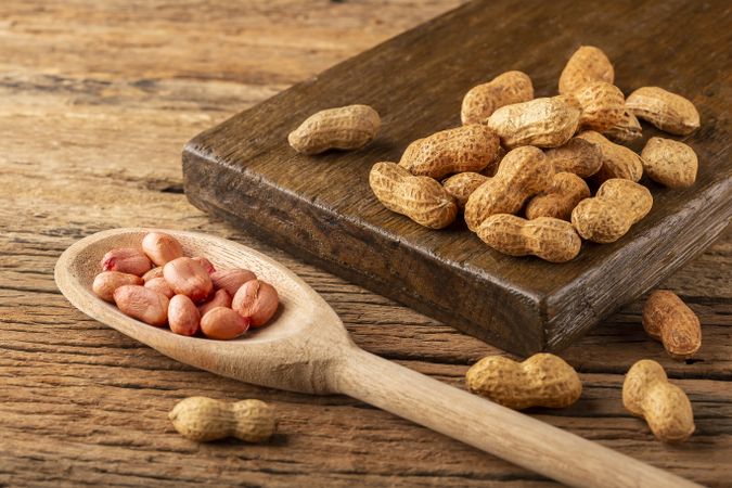 Dry peanut on the wooden background.