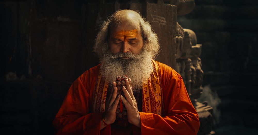 Authentic Shot of An Indian Monk Practicing Yoga In A Temple Setting.