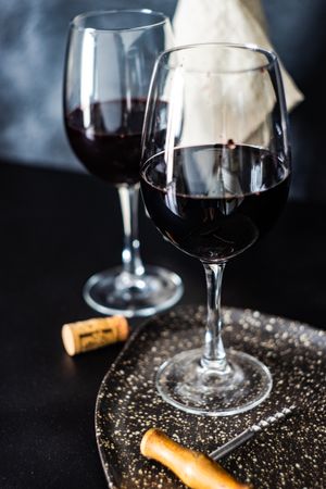 Red wine glasses with cork and opener