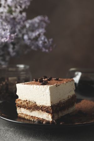 Composition with tasty tiramisu and lilac. Delicious dessert