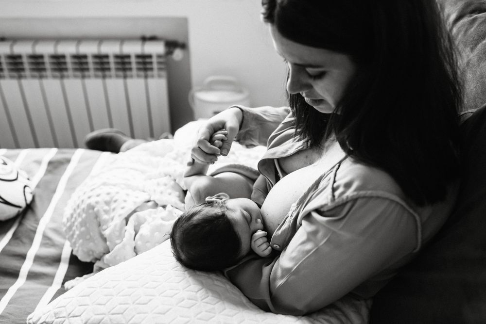 Mom breastfeeding at home