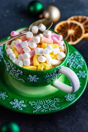 Marshmallow hot chocolate drink in green cup