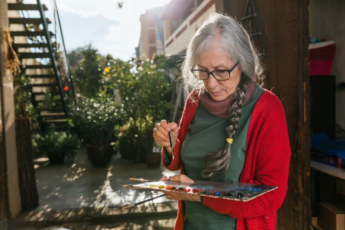 Mature painter with paint palette