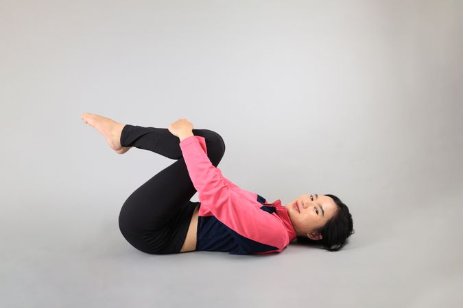 Young Woman doing Yoga Stretching Exercises