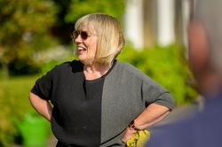 Female with hands on hips in garden