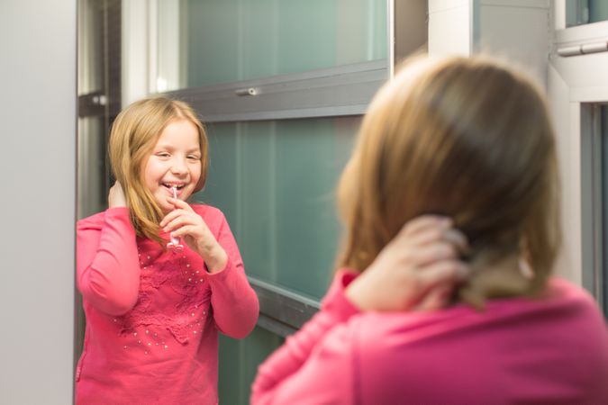 Cute girl brushing her teeth