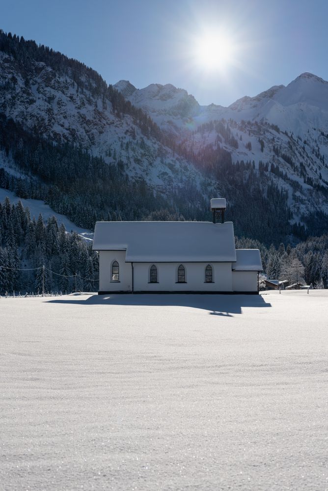 Sunny winter scenery with deep snow nature and bright sun in the sky